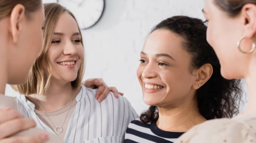 four women in recovery talking close to each other