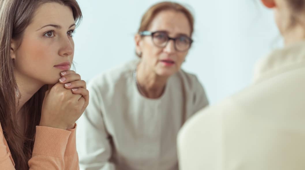Mature spiritual guide talking with young women