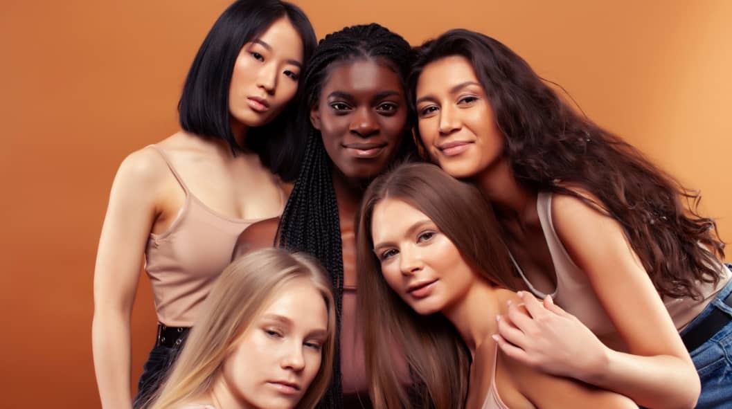 pretty asian, caucasian, afro woman posing cheerful together