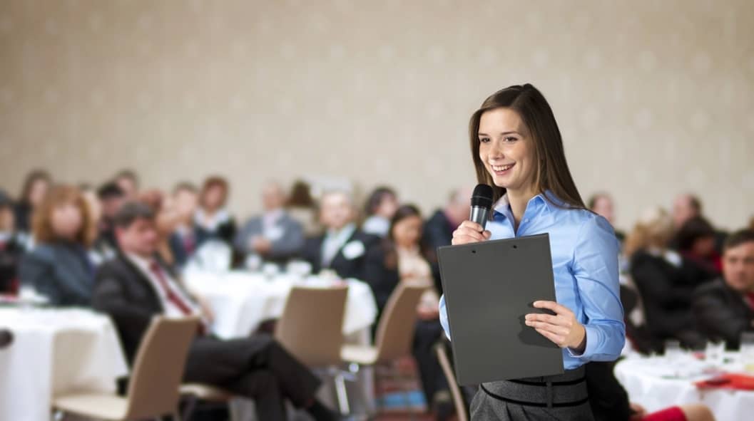 woman speaking in front of an audience