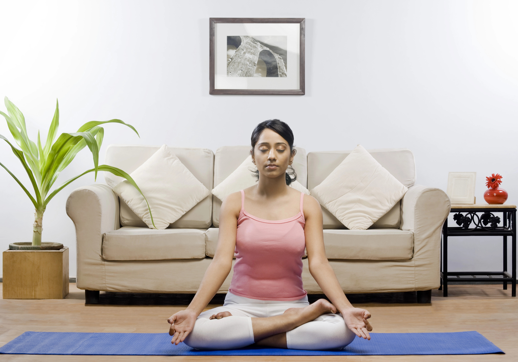 woman doing yoga in the living room for self-care