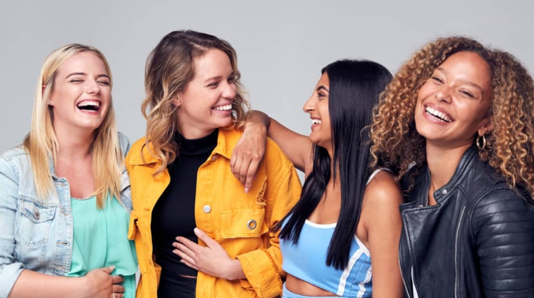 four women in recovery laughing together