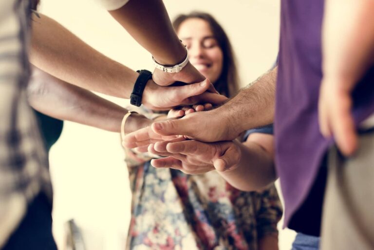 Group-of-diverse-people-joined-hands-together