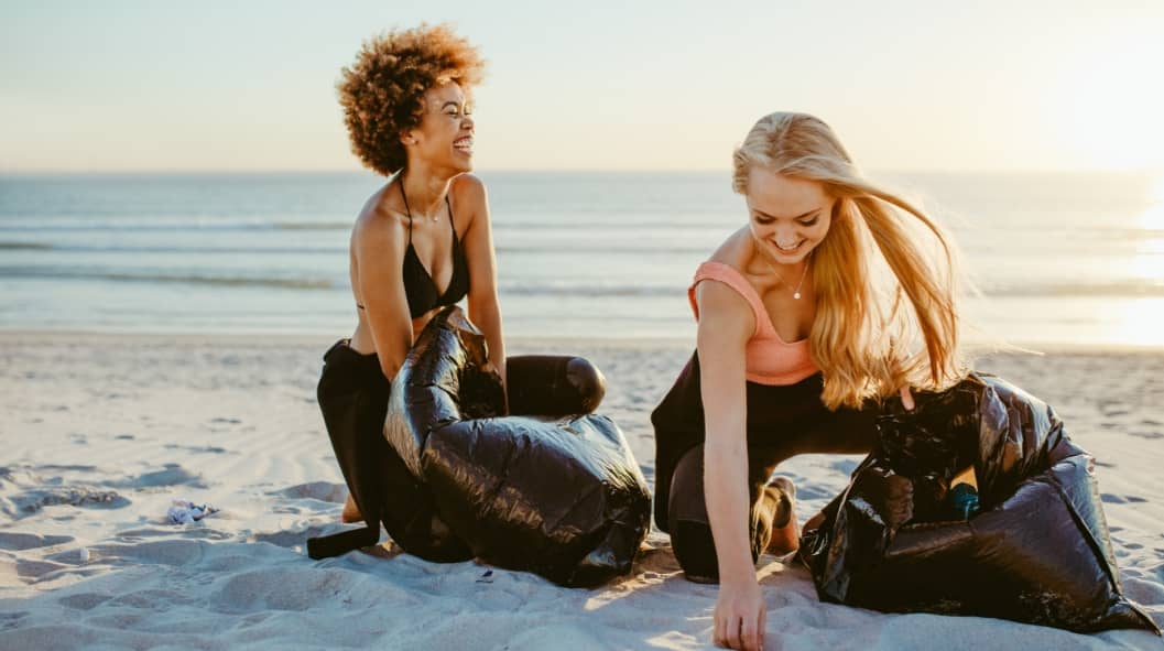 Women cleaning up beach area