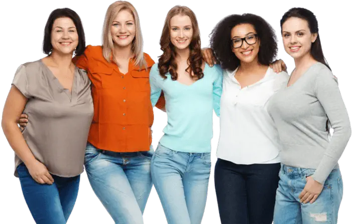 Five women standing closely together, smiling, and posing for a photo. They are dressed casually in a variety of tops and jeans.