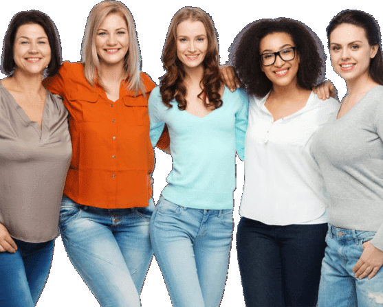 Five women stand closely together, smiling, wearing casual outfits including jeans and various colored tops against a white background.