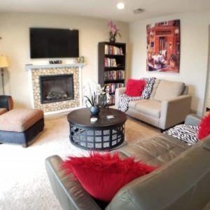 living room of a sober living house with flat screen TV and fireplace