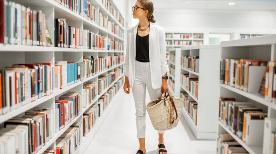 woman looking and checking books in the library