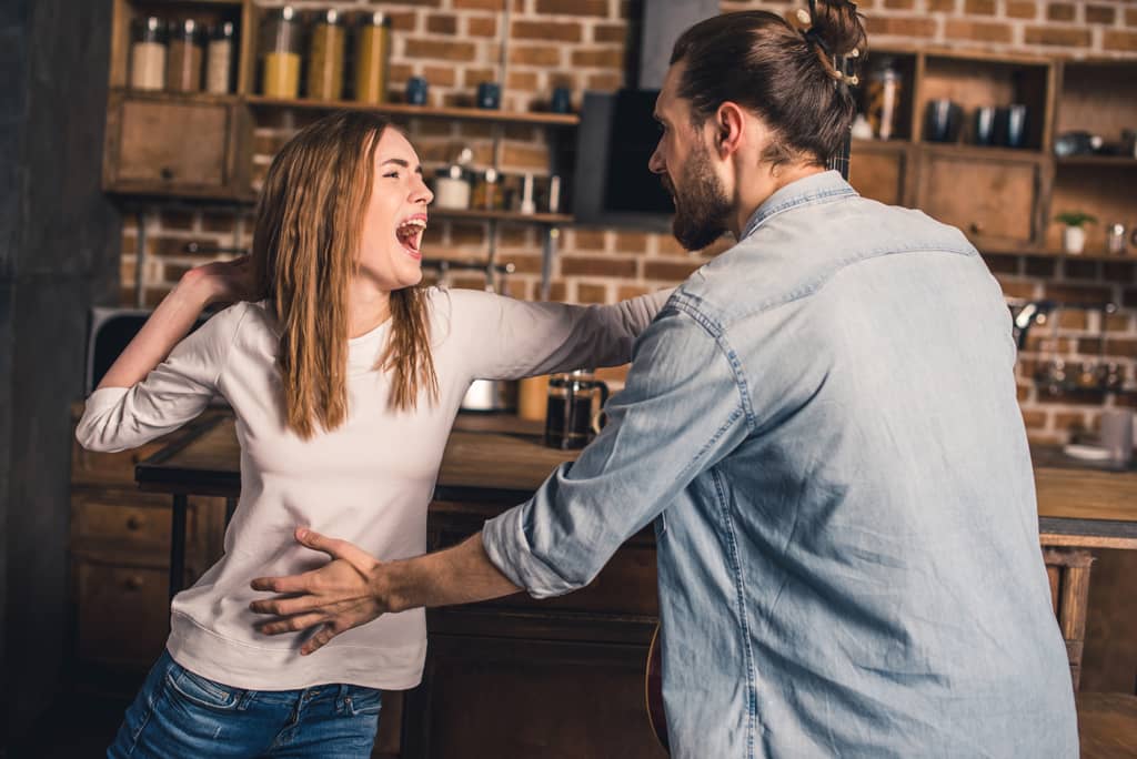 woman about to slap a man in an argument