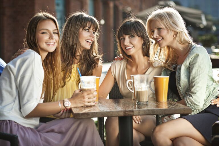 four women talking over coffee