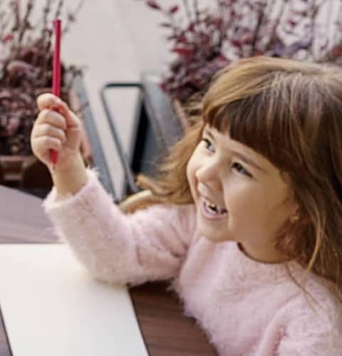 Mother-And-Daughter-Drawing-With-Pencils-Helping-Her-Child-Draw-A-Picture-In-Cafe mobile