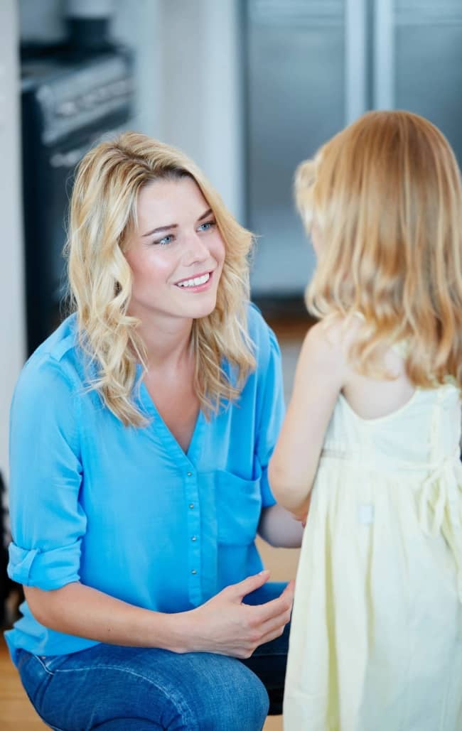 young mother talking to her daughter at home.