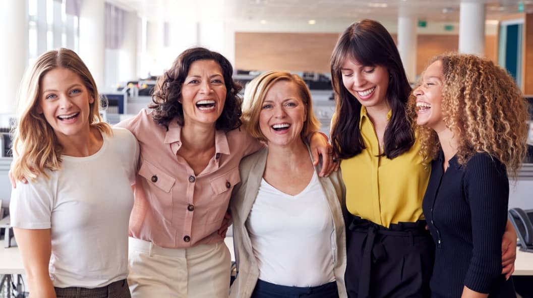 Portrait Of Smiling Female Business Team Working In Modern Office Together