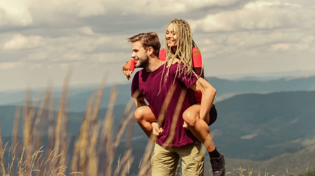 Beautiful couple embracing landscape background