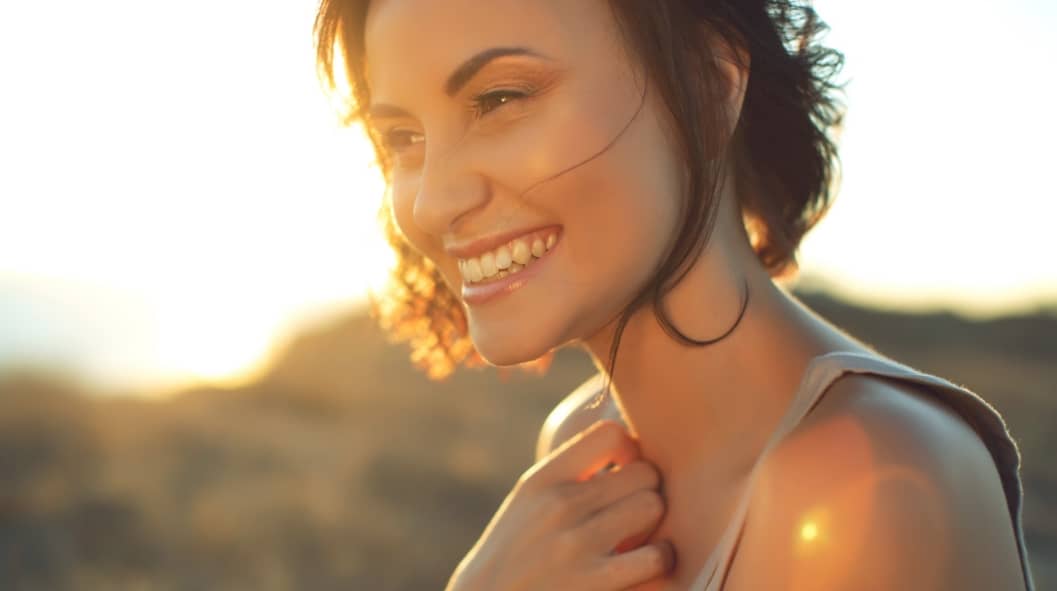 Portrait of a beautiful young girl at sunset