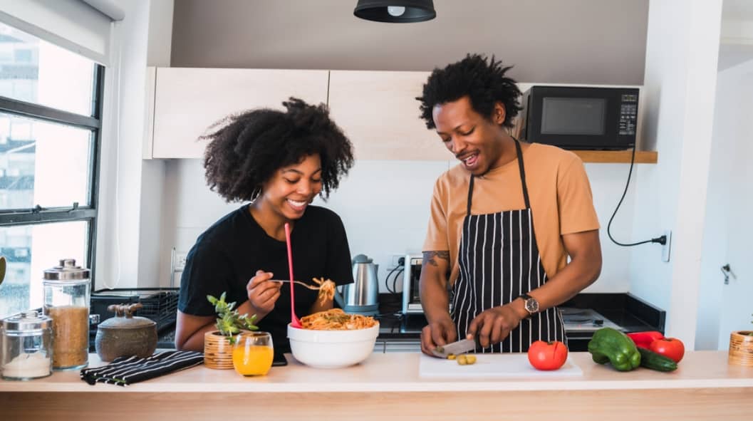 Portrait of young afro couple cooking together