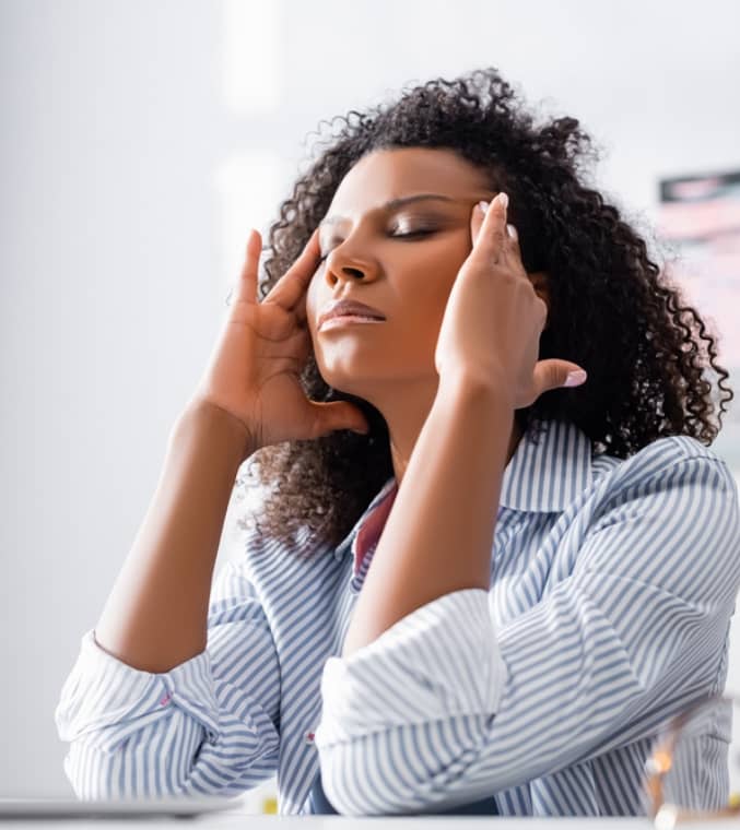 Tired african american woman suffering from hangover