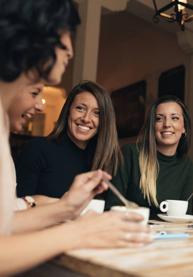 women drinking coffee and chatting
