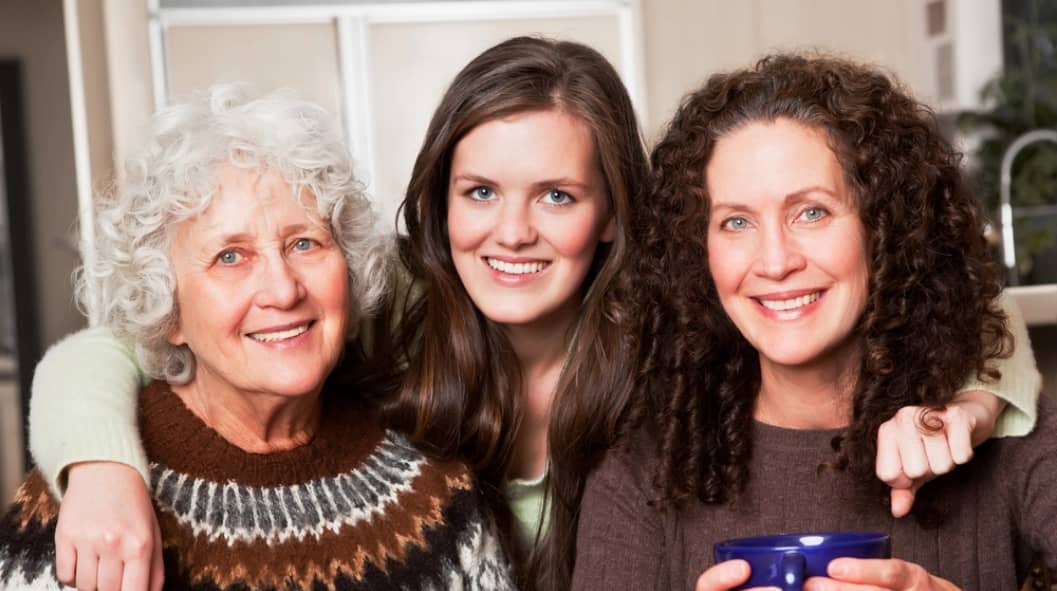 three smiling women in sober living community